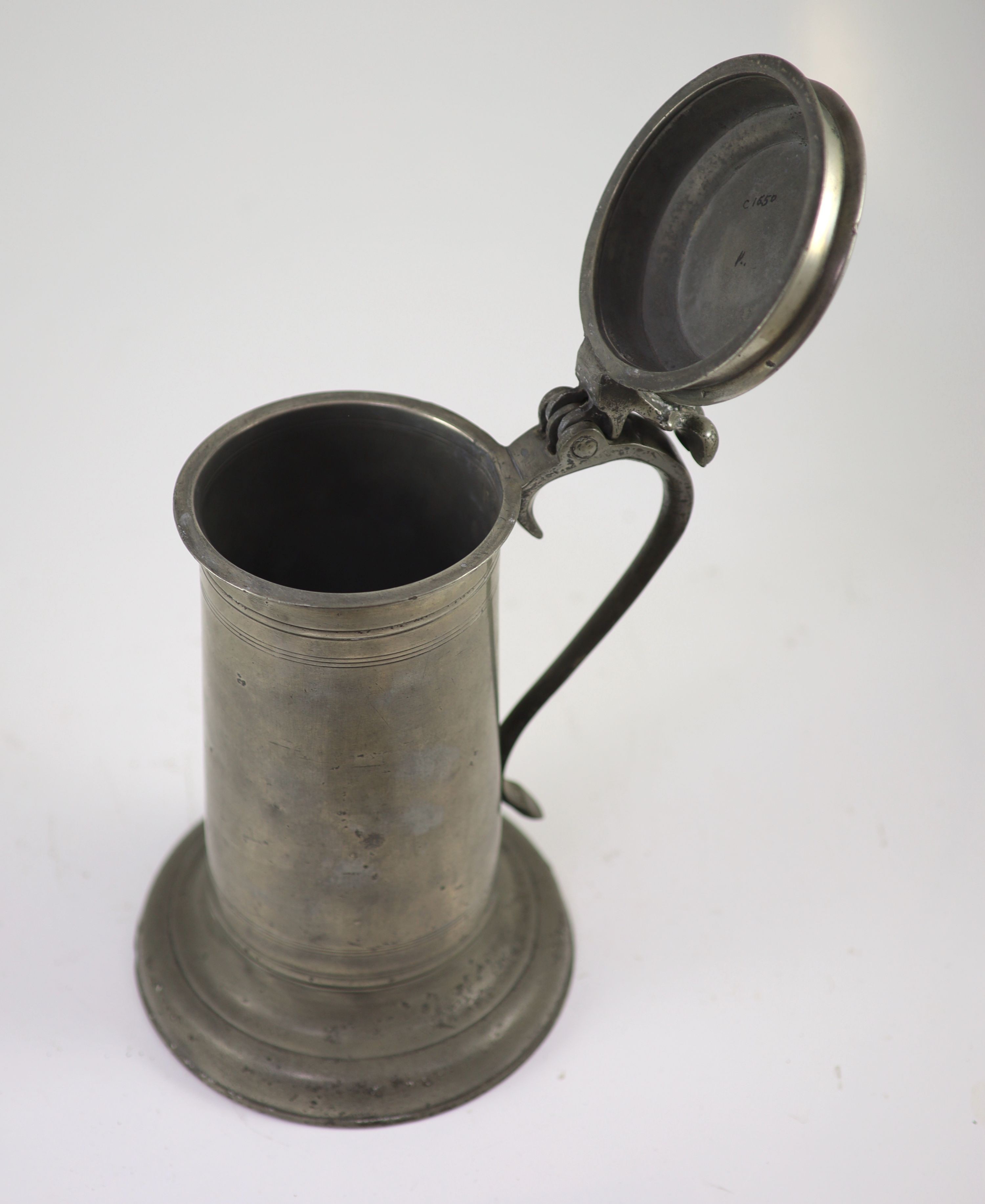 A mid-17th century pewter flagon of large proportions H 31cm.
